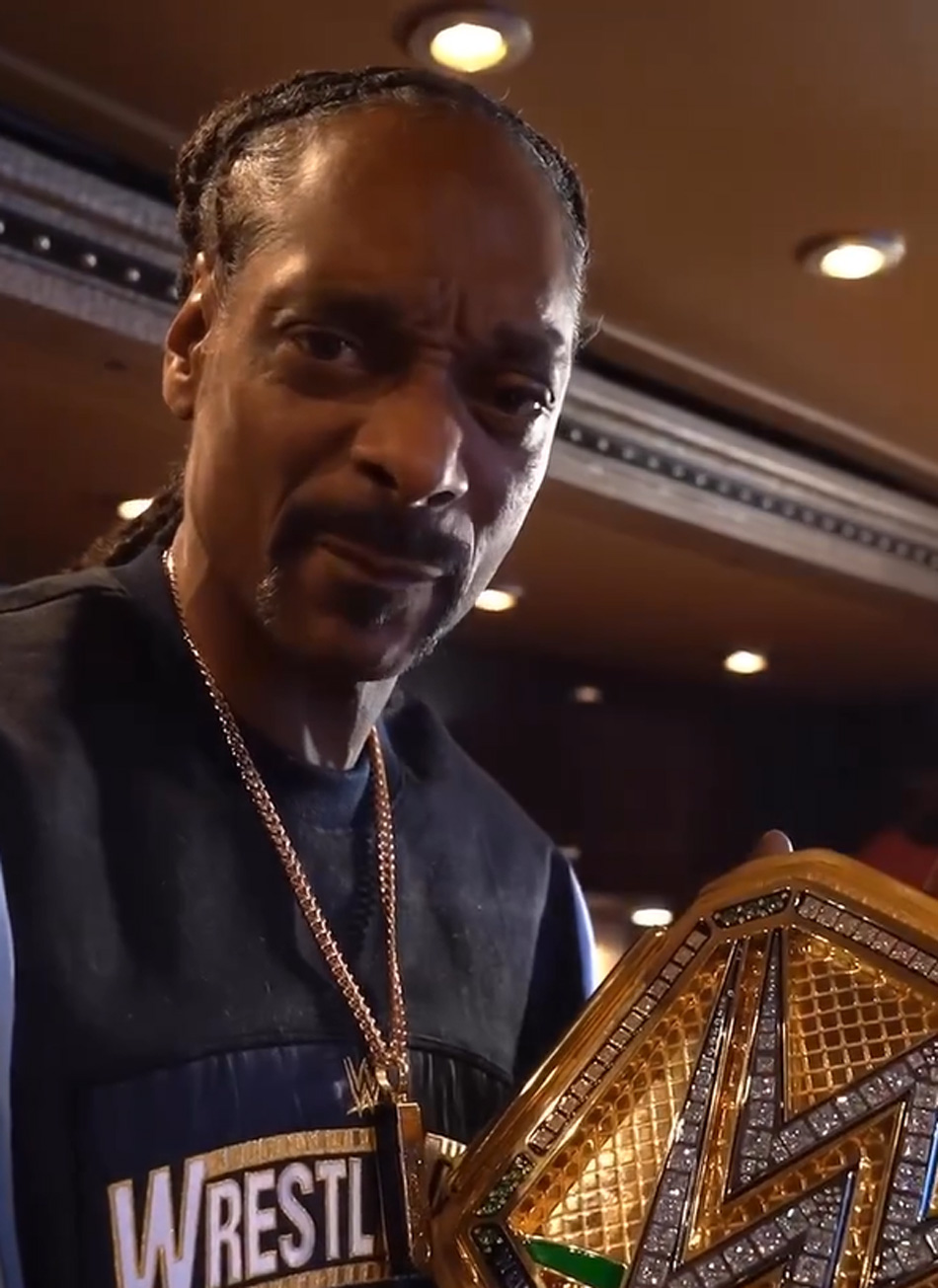 Snoop Dogg holding his WWE golden title